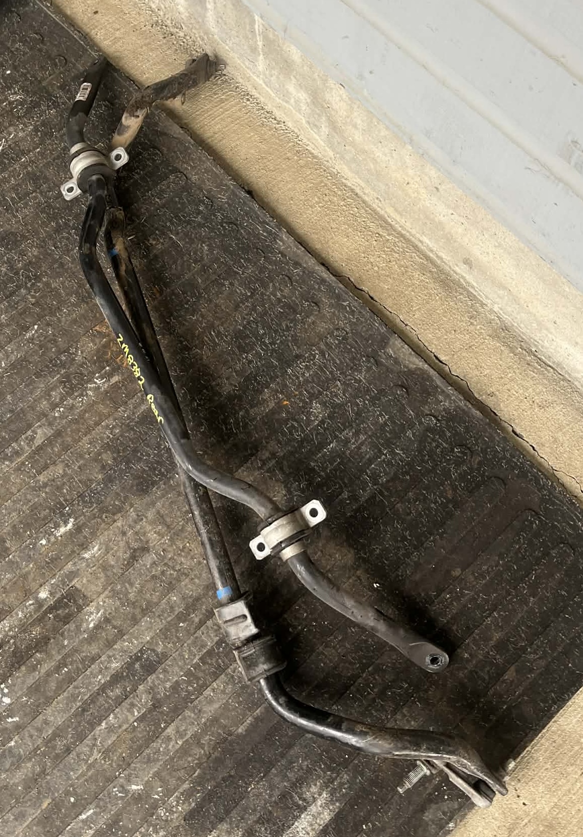 The C6 Z06 sway bars we were able to source for the Dead to Shred C5 Corvette, laying on a carpet. Not glamorous, but functional!