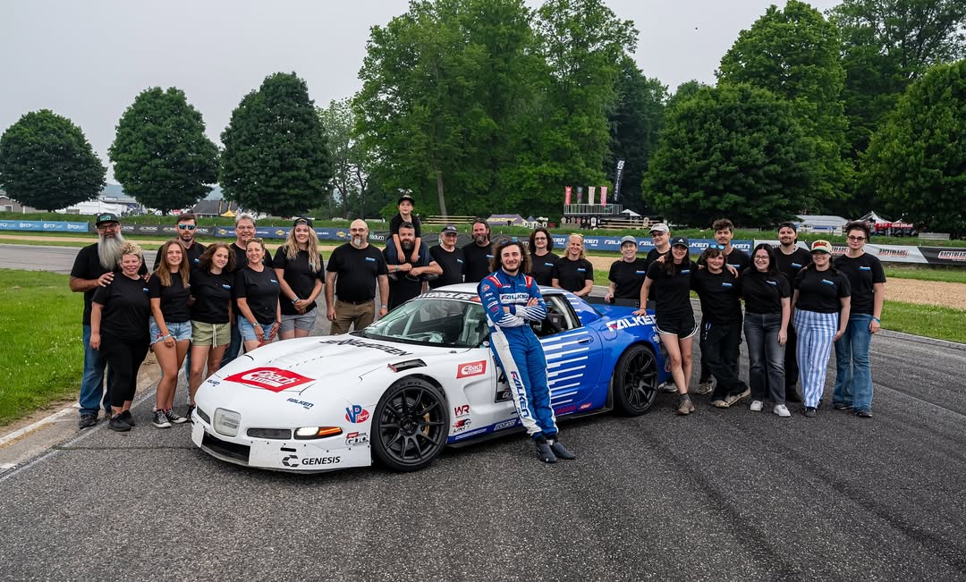Matan Rosenburg posing with his entire team and their C5 Corvette
