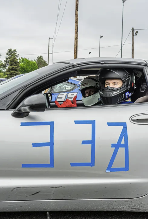 Shred Jesse and Mrs. Shred in the D2S C5 Corvette awaiting their turn in the autocross queue. The number 333 are on the side, with the last 3 cross off to indicate which of the two drivers were up.