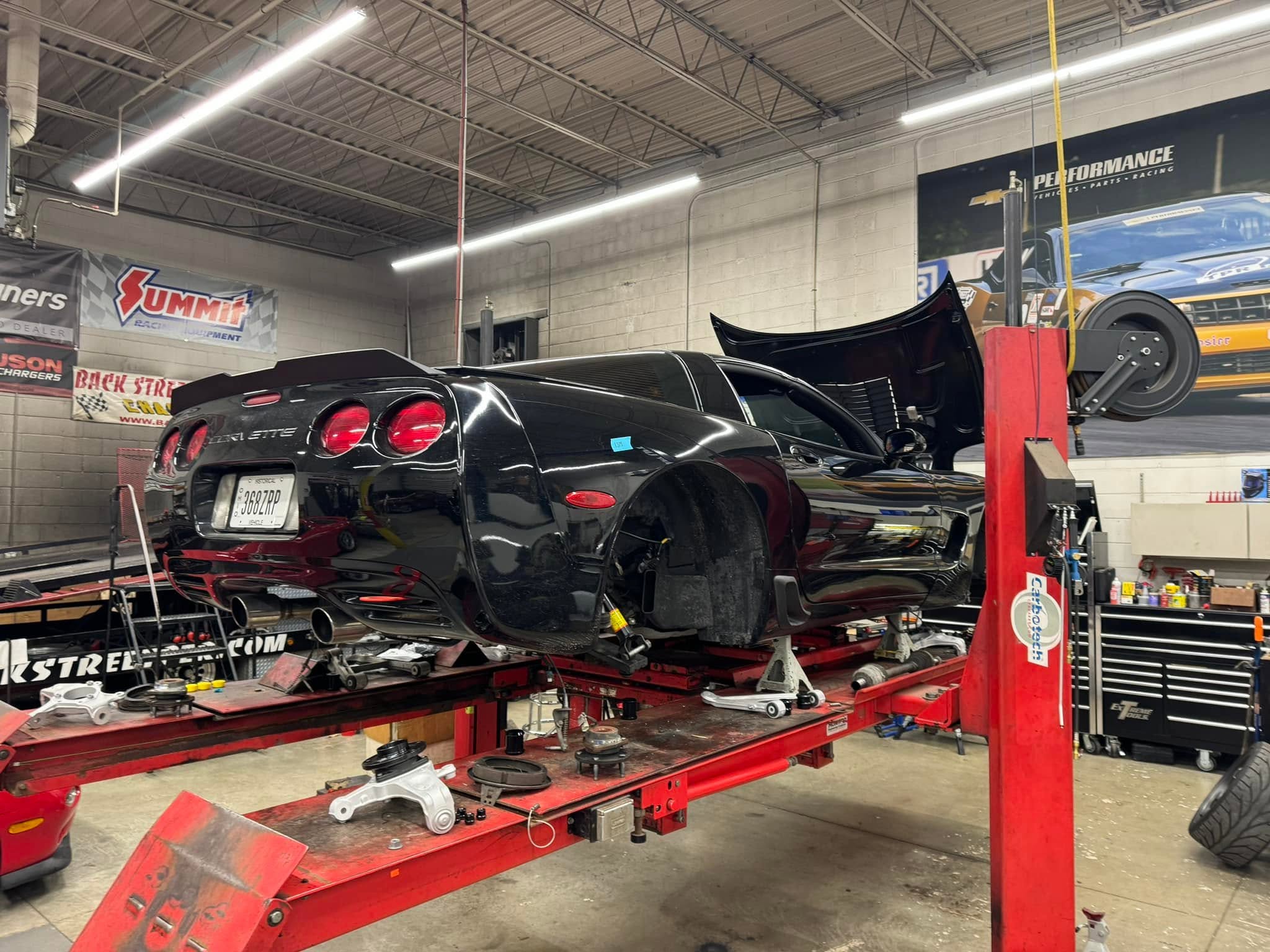 Brian's C5 Corvette in the air on a lift being worked on as part of the incoming modifications for more power.