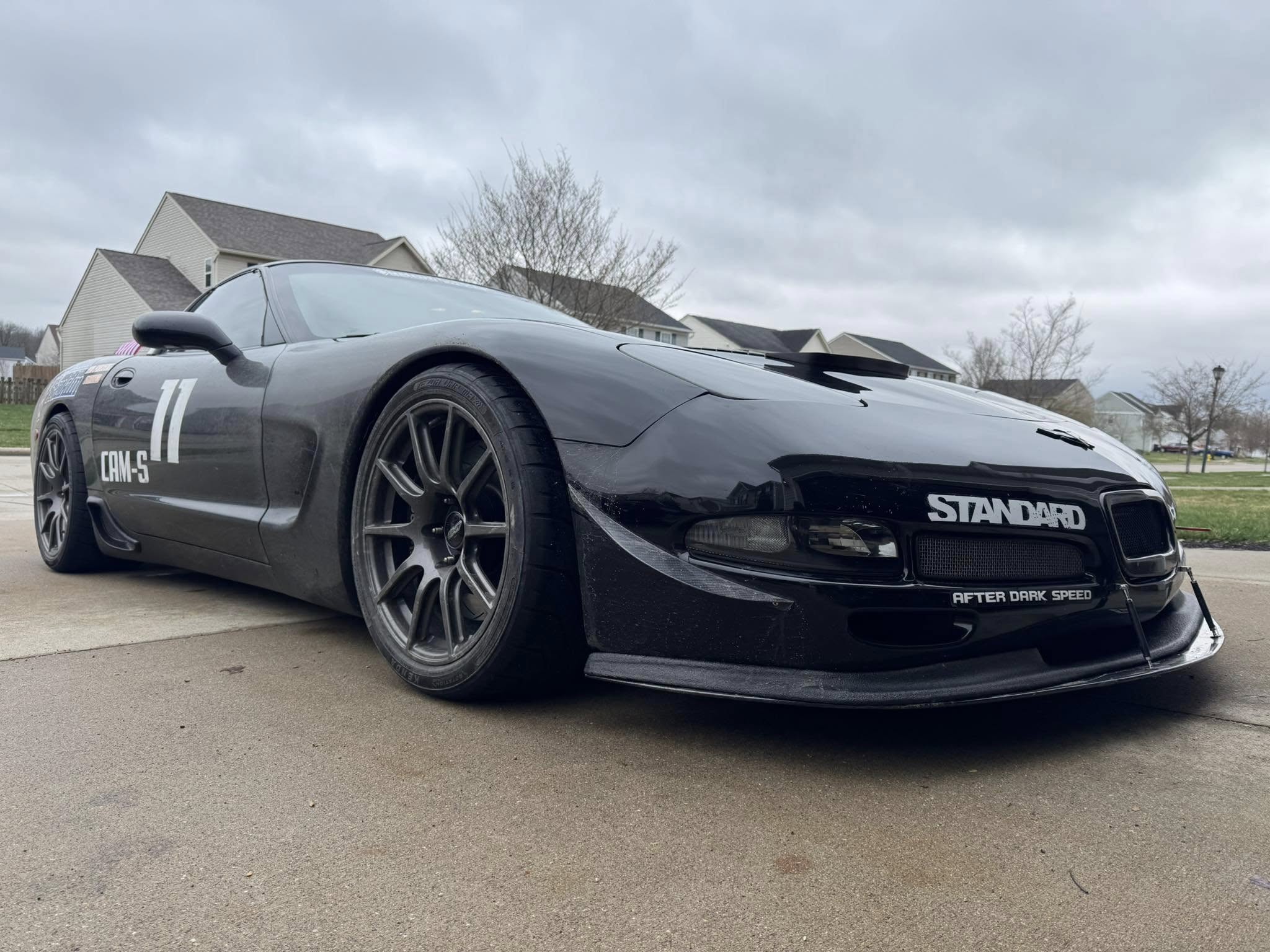 Brian Wick's all black c5 Corvette in it's final state, as seen from the front passenger side. It has a splitter and canards as well now.