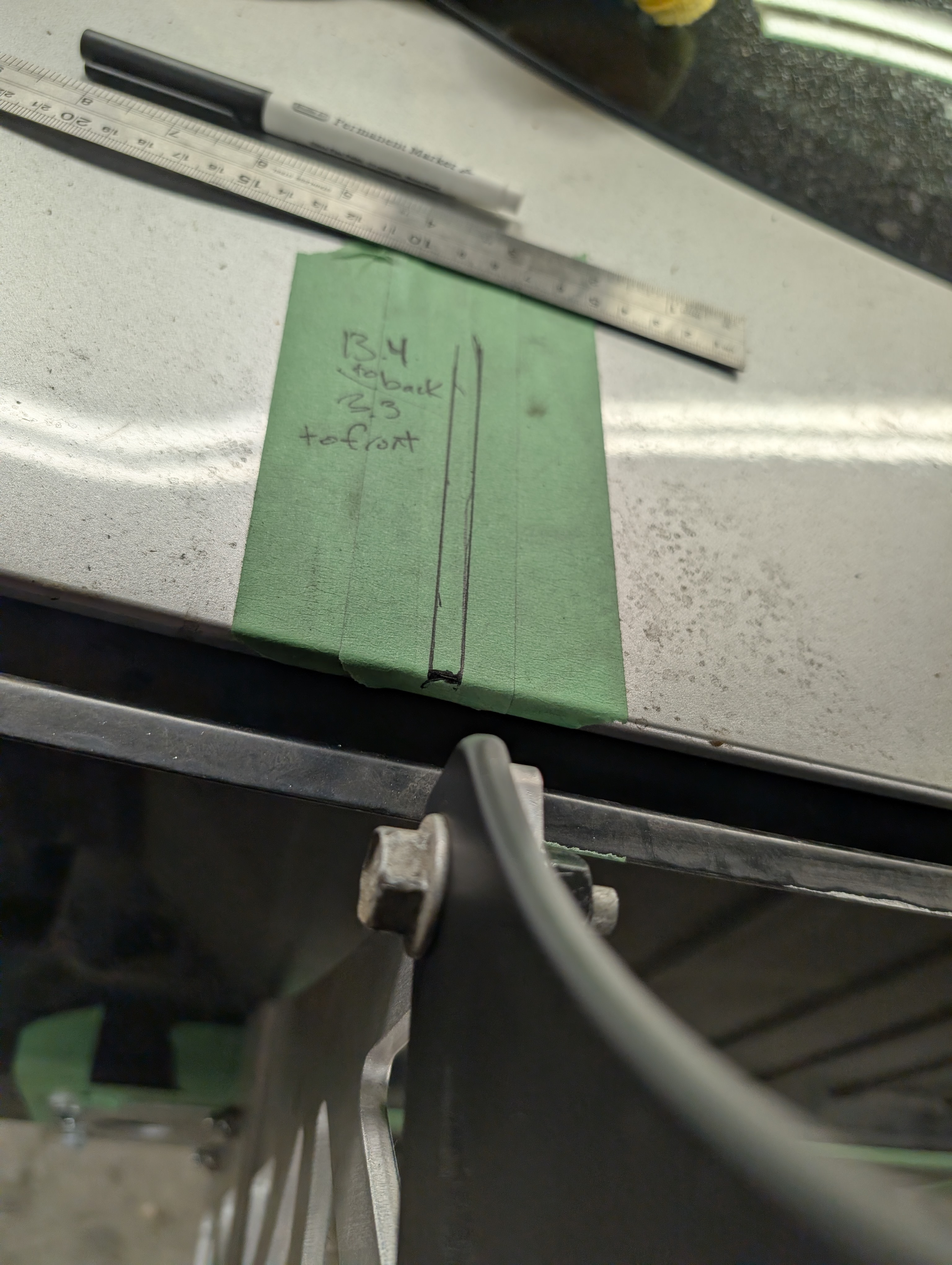 A picture of the rear deck lid measuring technique used to install a chassis mounted wing on a C5 Corvette