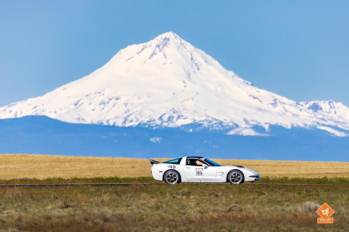 A white C5 Corvette with the numbers #199 at Oregon Raceway Park in front of Mt Hood
