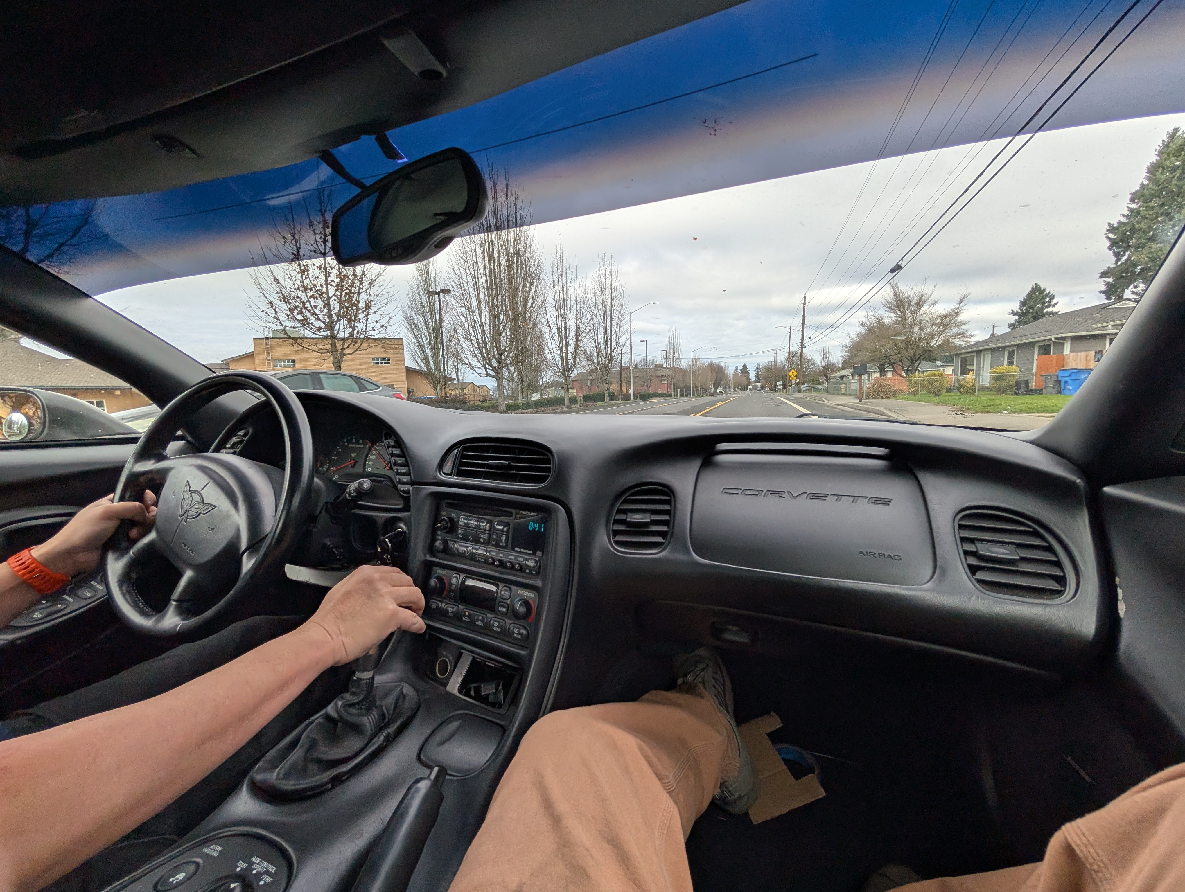 A picture of the Dead to Shred Corvette driving down the street, taken from inside by Shred Jesse in the passenger seat.