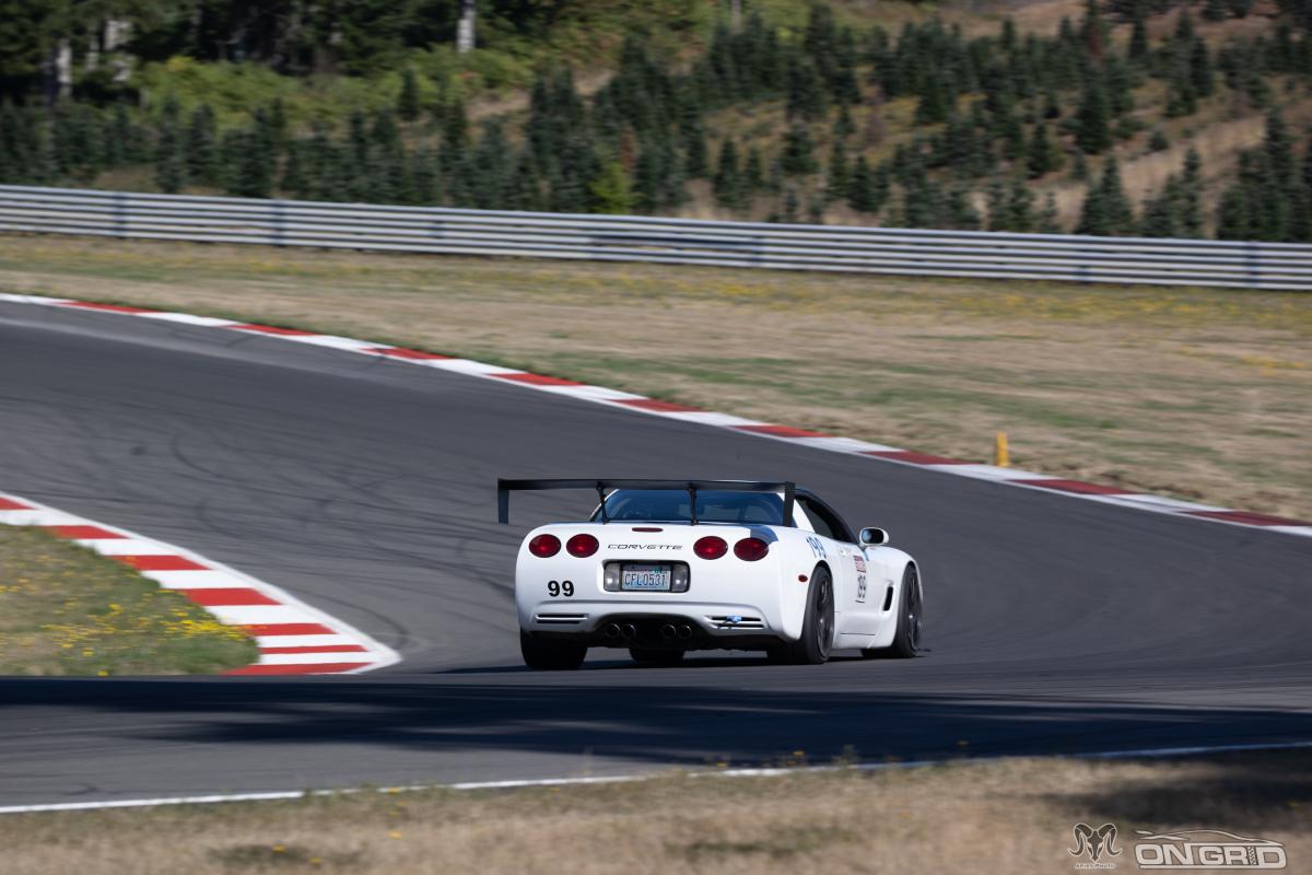 A White C5 Corvette rear end cornering at the Ridge during a time attack event.