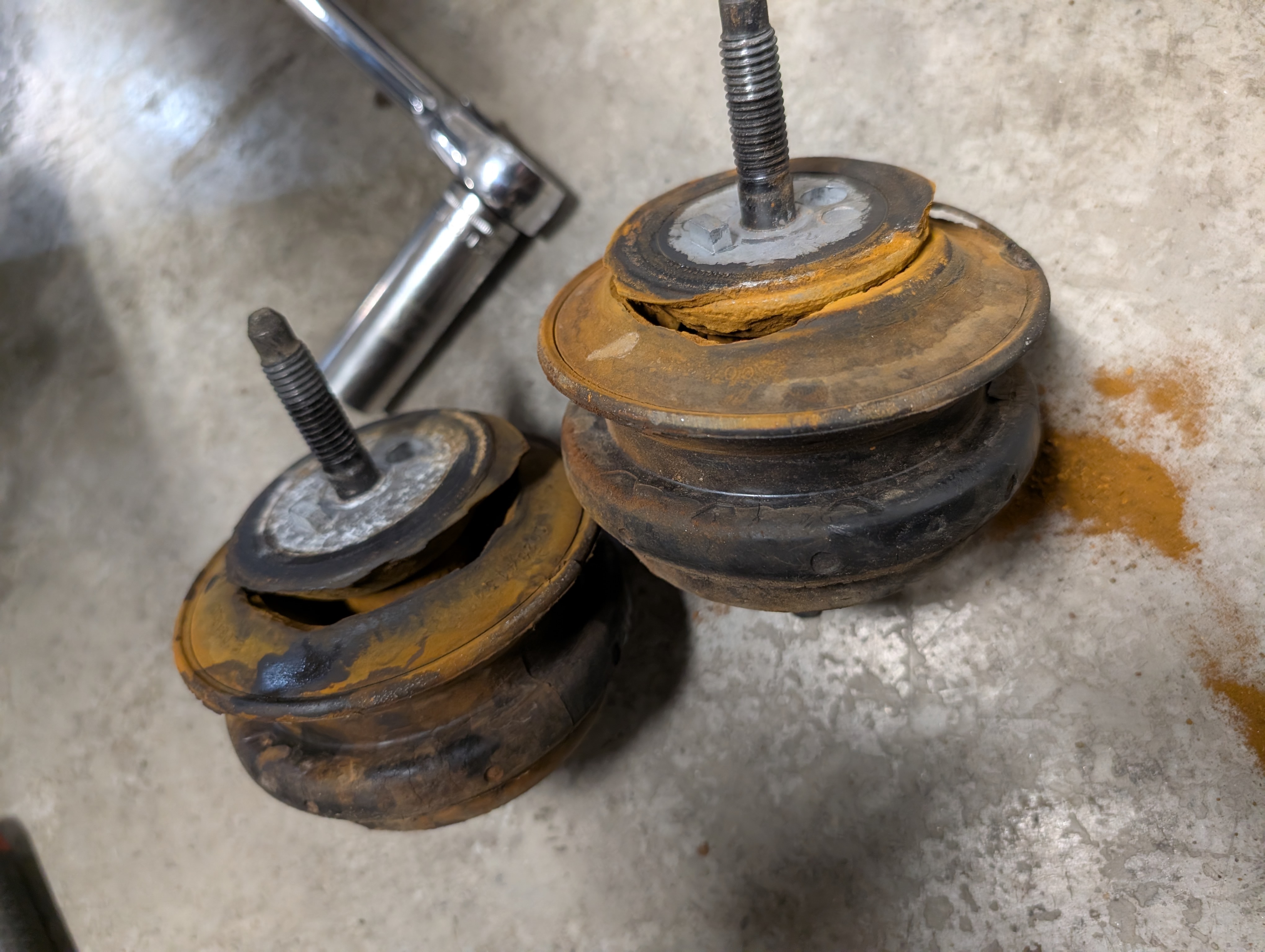 Two blown C5 Corvette motor mounts, specifically showing they ripped and separated at the bottom.