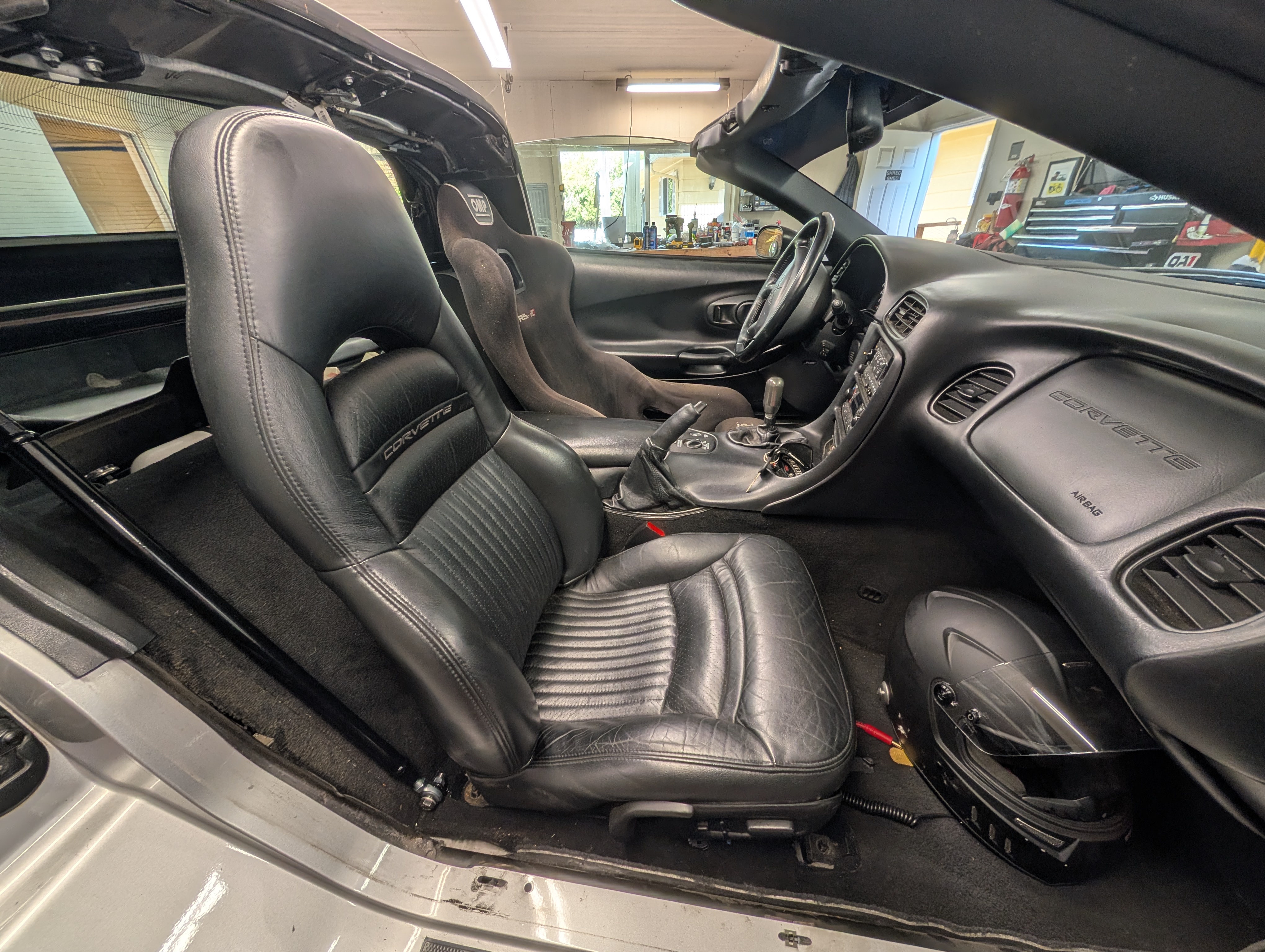 A picture from the passenger side of the full modified interior of the Dead to Shred C5 Corvette with a drivers side bucket seat and harness bar.