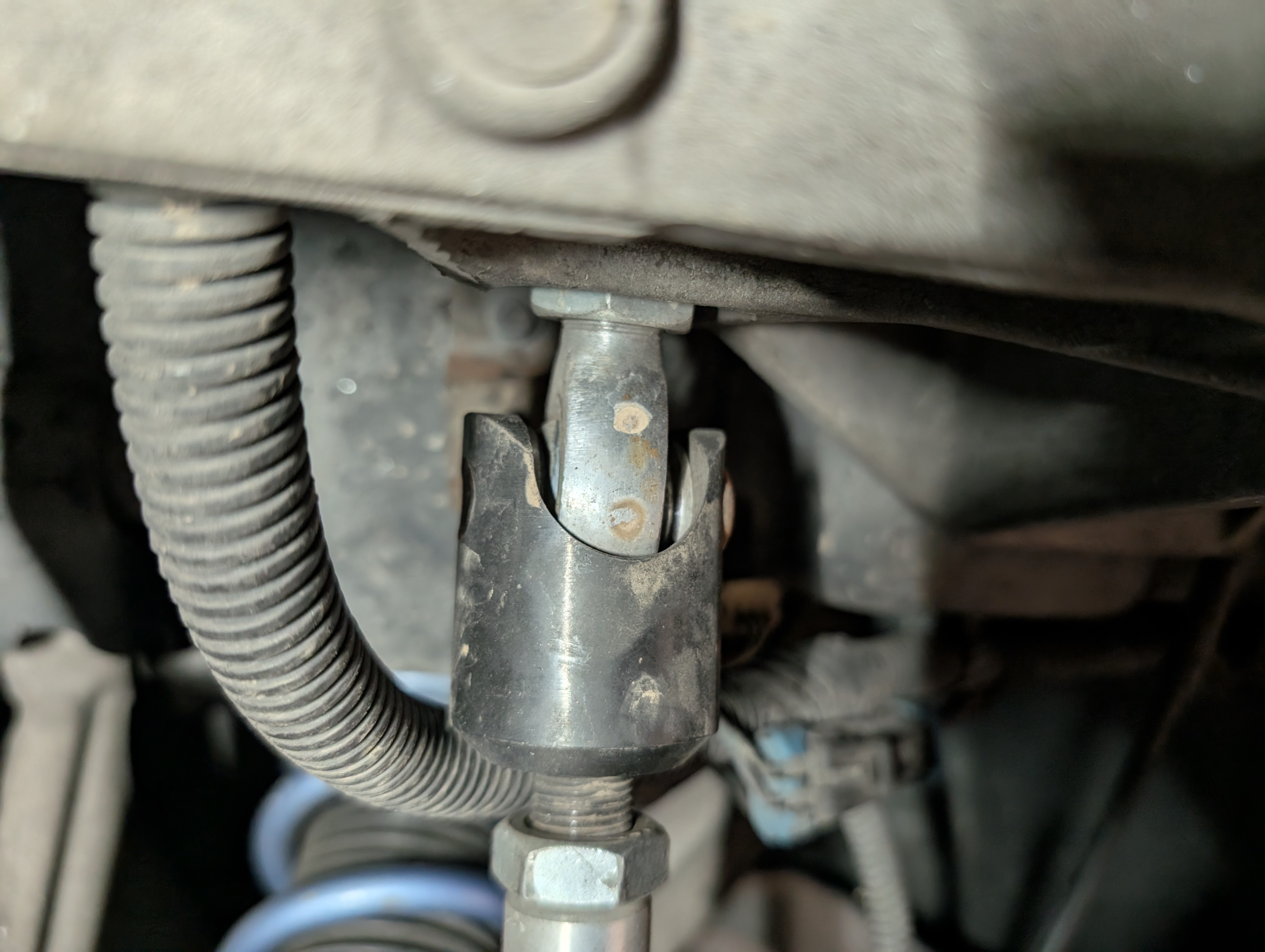 A picture of the good side of an aftermarket C5 Corvette inner tie rod connector. It has the correct torx bolt instead of a bolt and nylock nut jammed through the entire thing.
