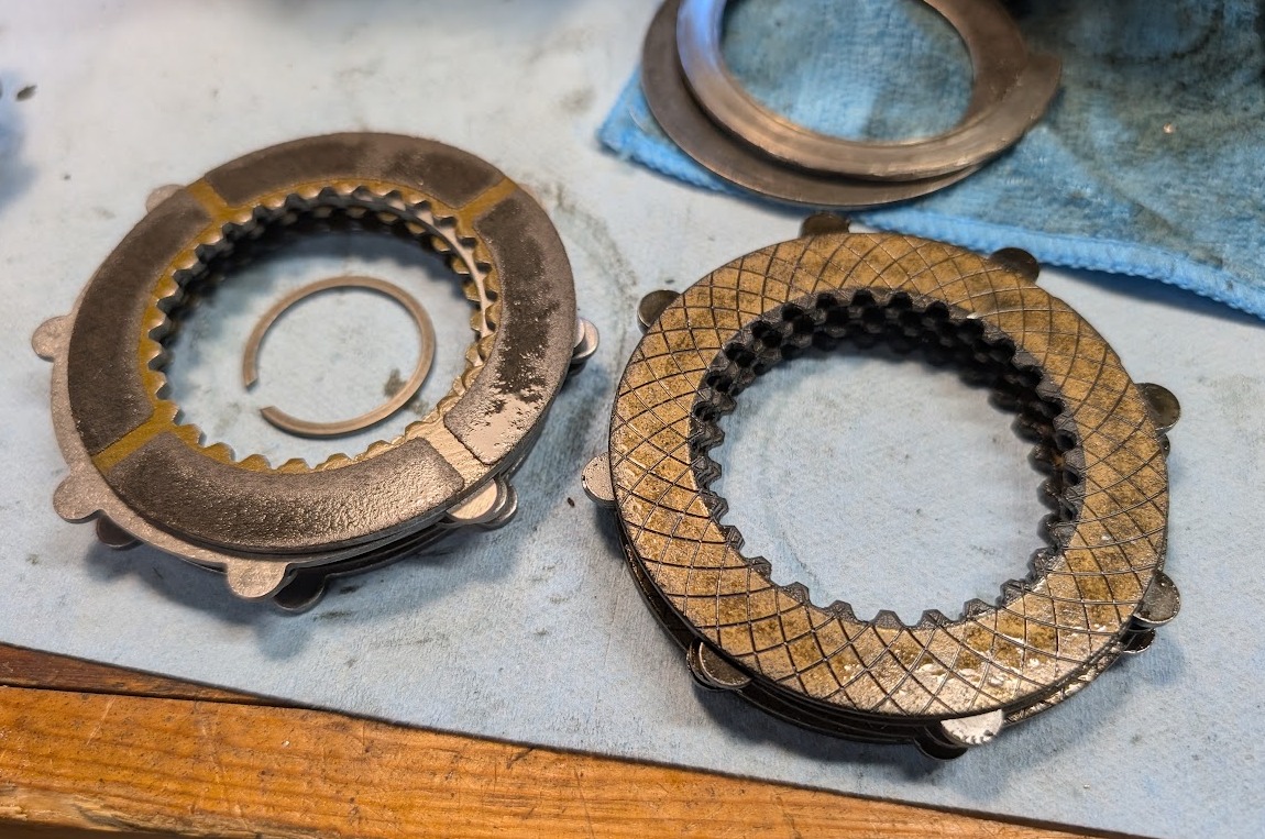A stack of fresh C6 Z06 Corvette clutch packs next to OEM C5 Z06 clutch packs.