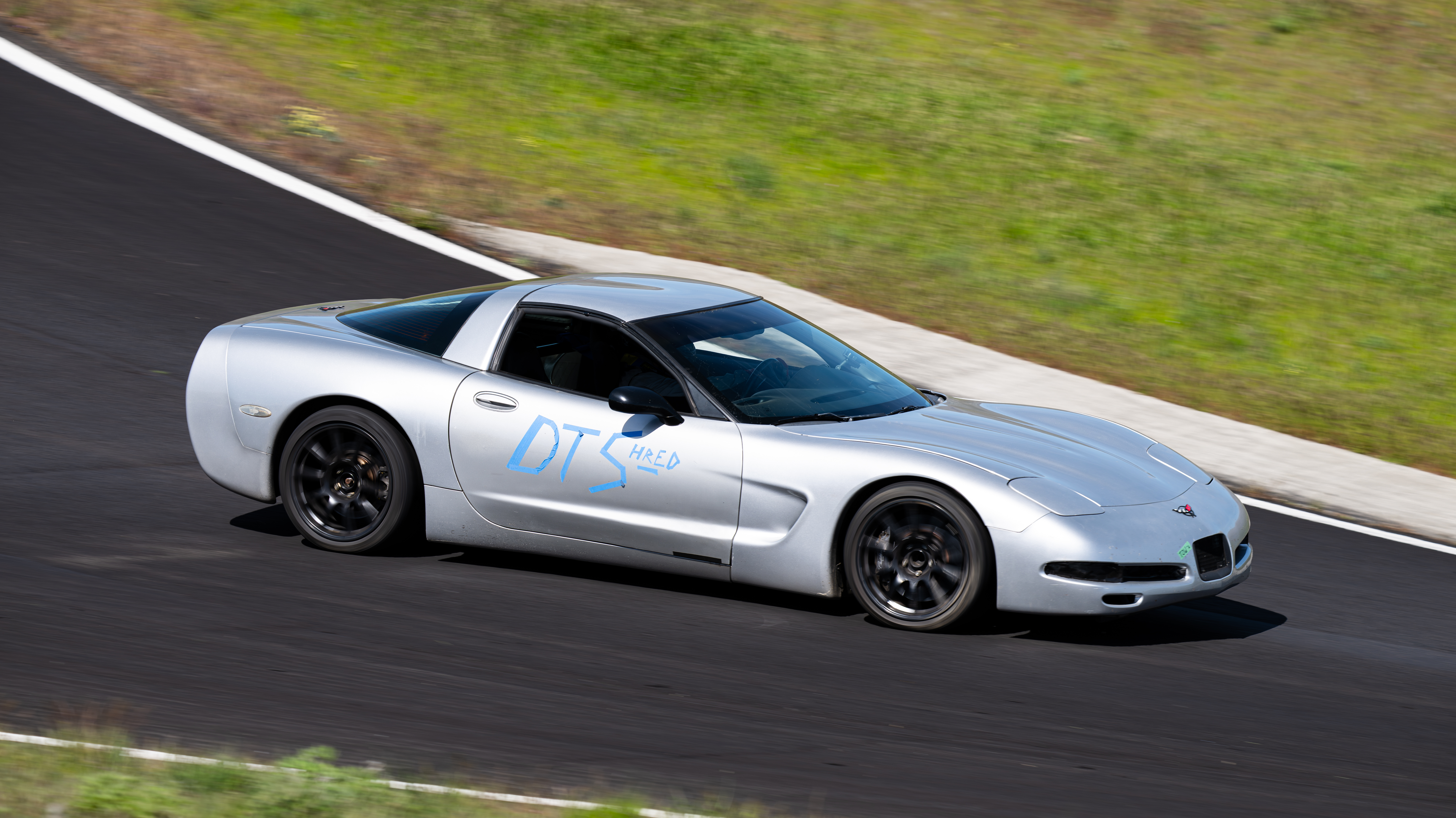 Dead to Shred Corvette mid corner with Shred Jesse piloting it. You can see the DTS blue painters tape on the side distinguishing it from other corvettes on track.