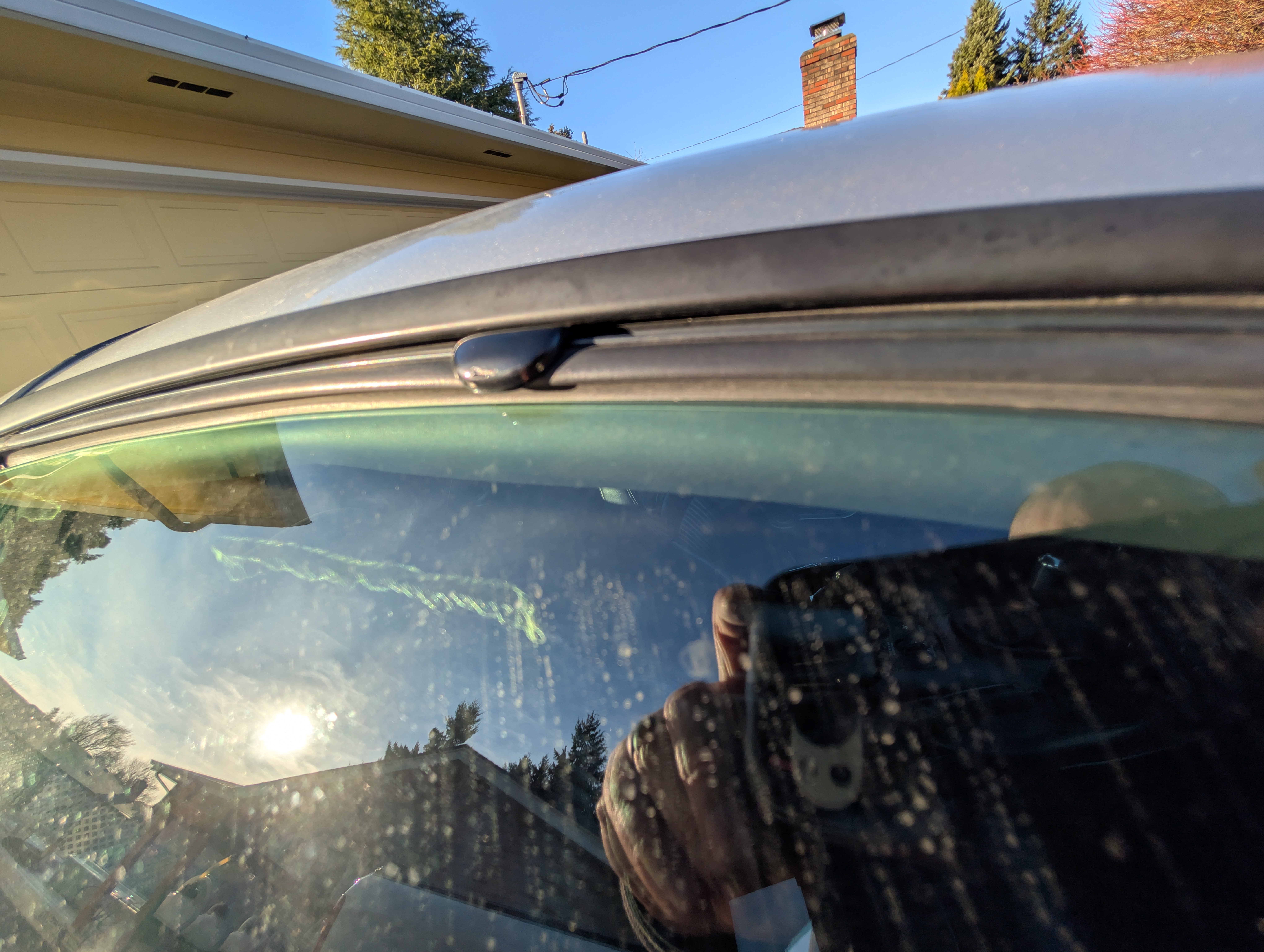 A c5 corvette window rolled all the way up but not fully engaging the ruber seal or the tab to hold the window in place at speed