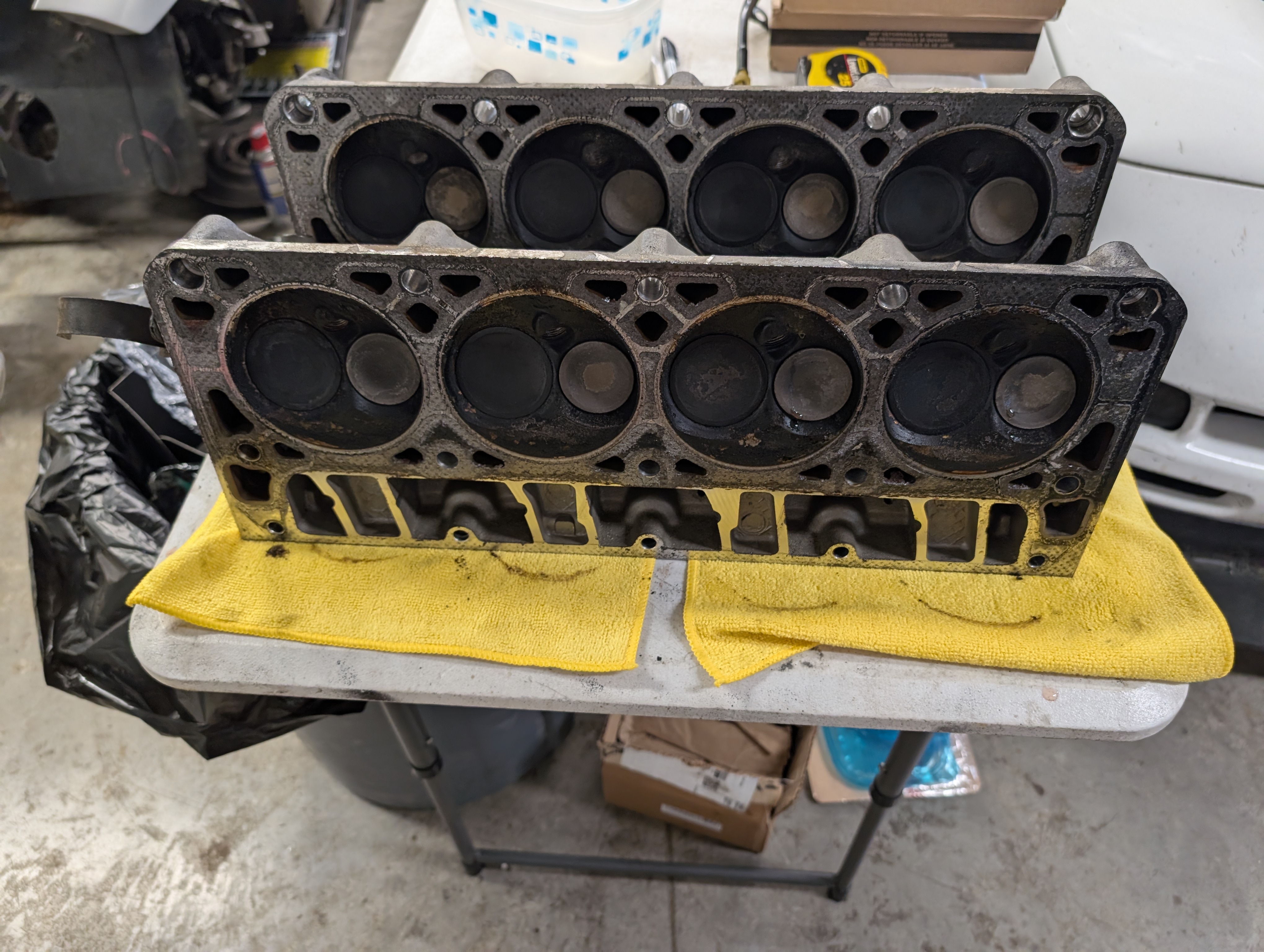 The dead to shred LS heads (241) on a table after removal. There is notable carbon buildup to be seen.