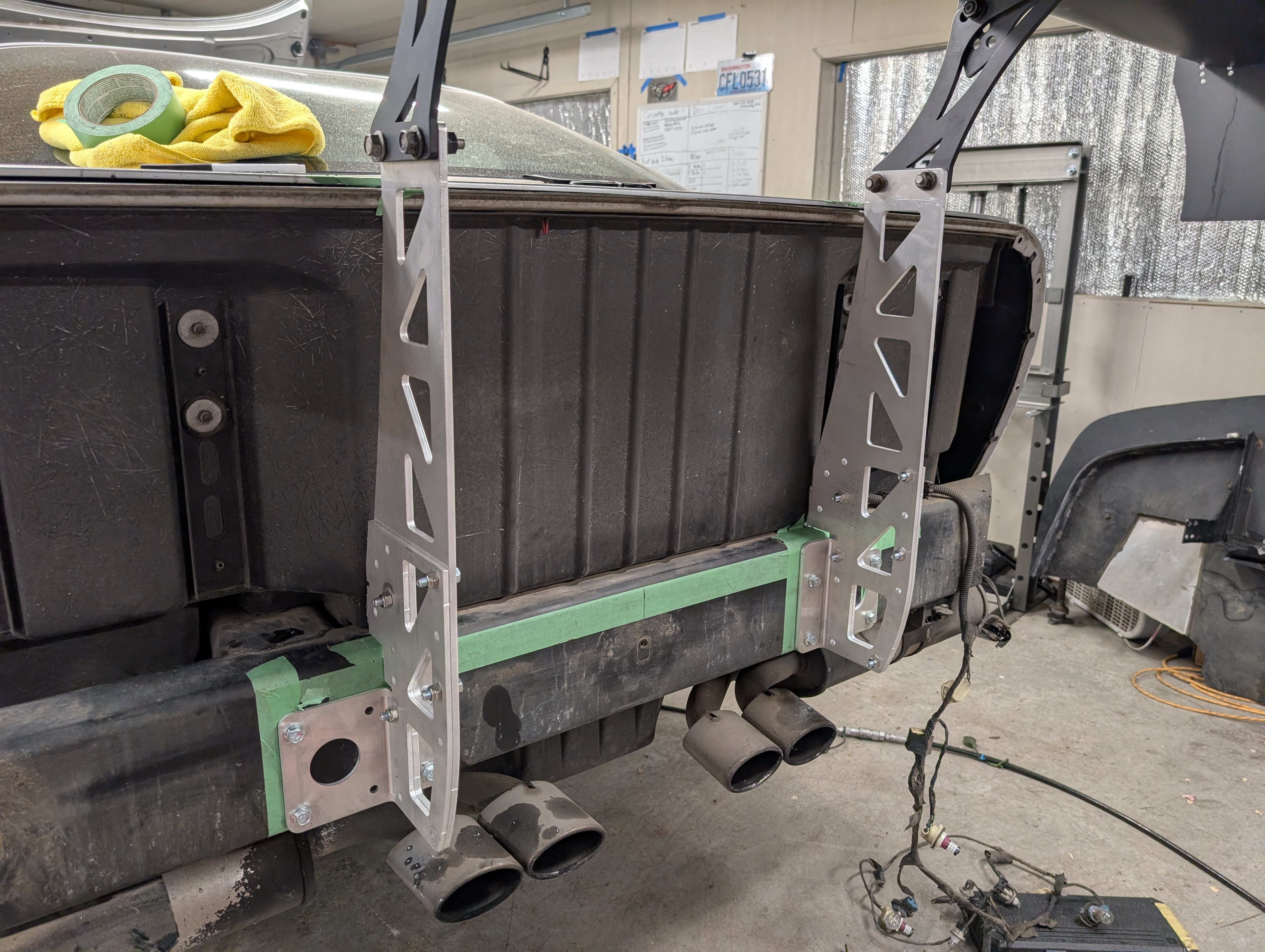 Wing chassis mounts on the back of a C5 Corvette, with no bumper so you can see the full structure of the wing mounts to chassis.