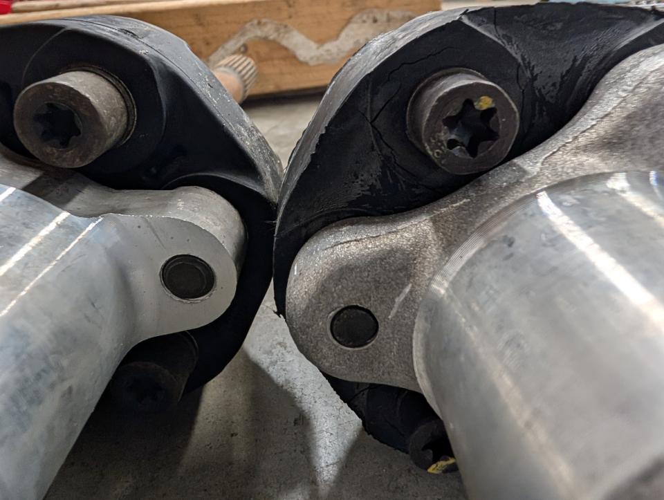 Two torque tube shafts with guibos side by side. One is the 10mm and one is the 12mm, though barely discernable.