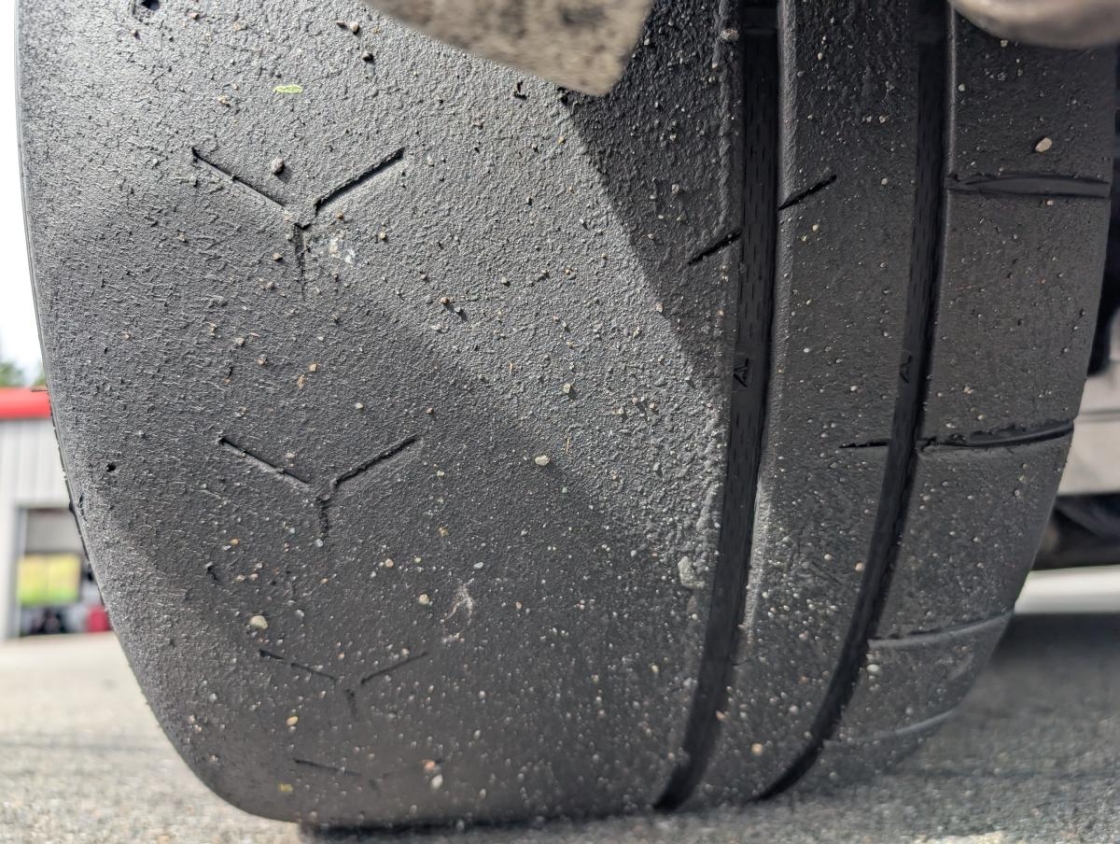 Vitour Sonic Tires as pictured with a tread on view on the ground.